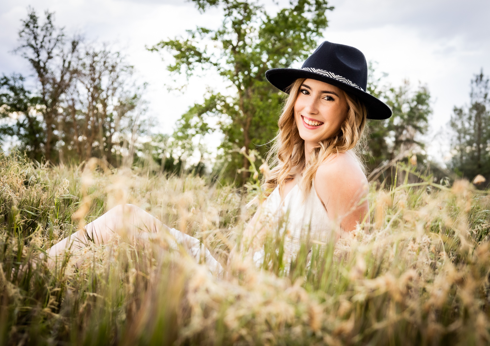 girl in black hat taking senior session in red bluff ca
