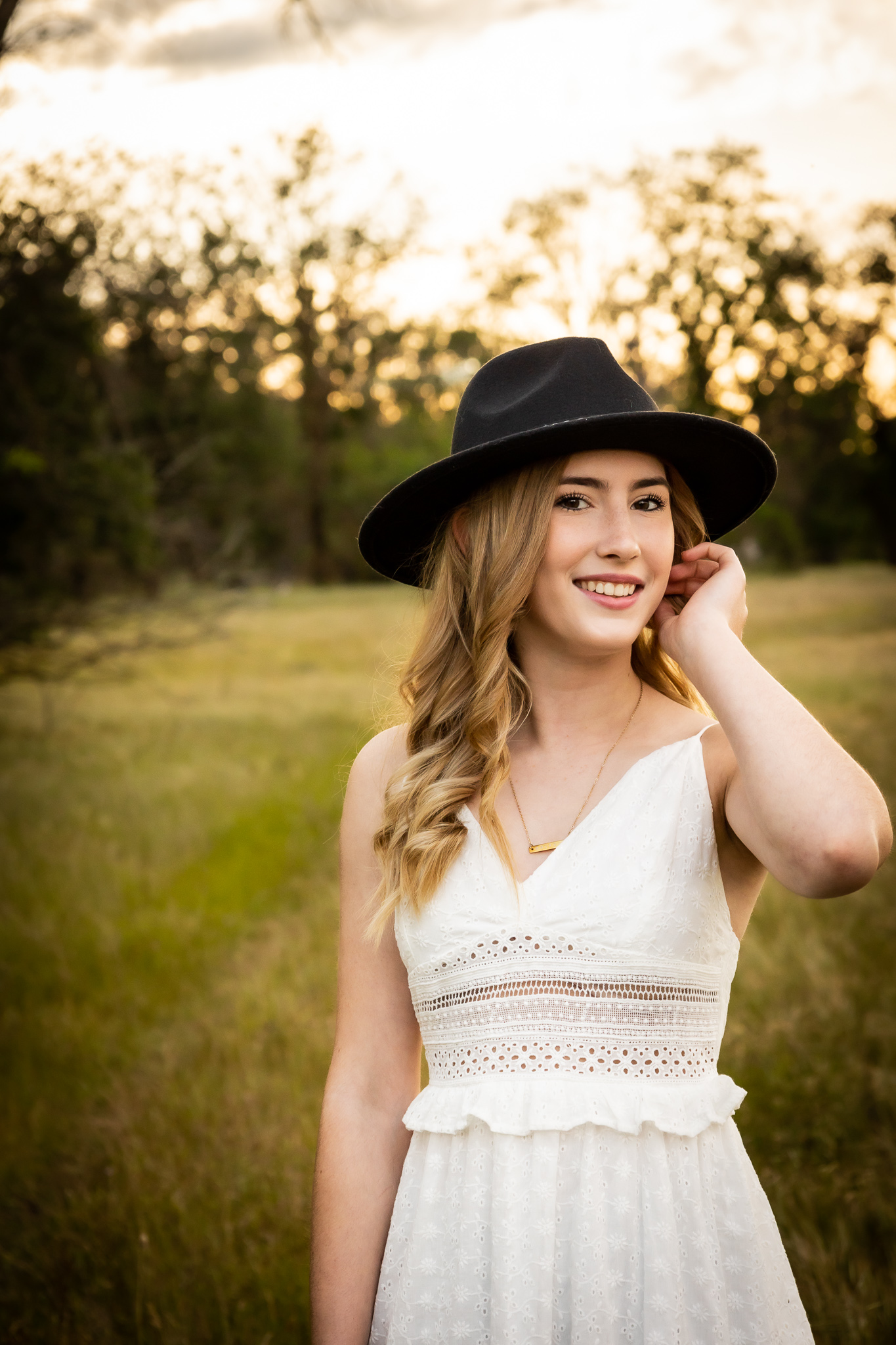 girl in black hat taking senior photos in red bluff ca