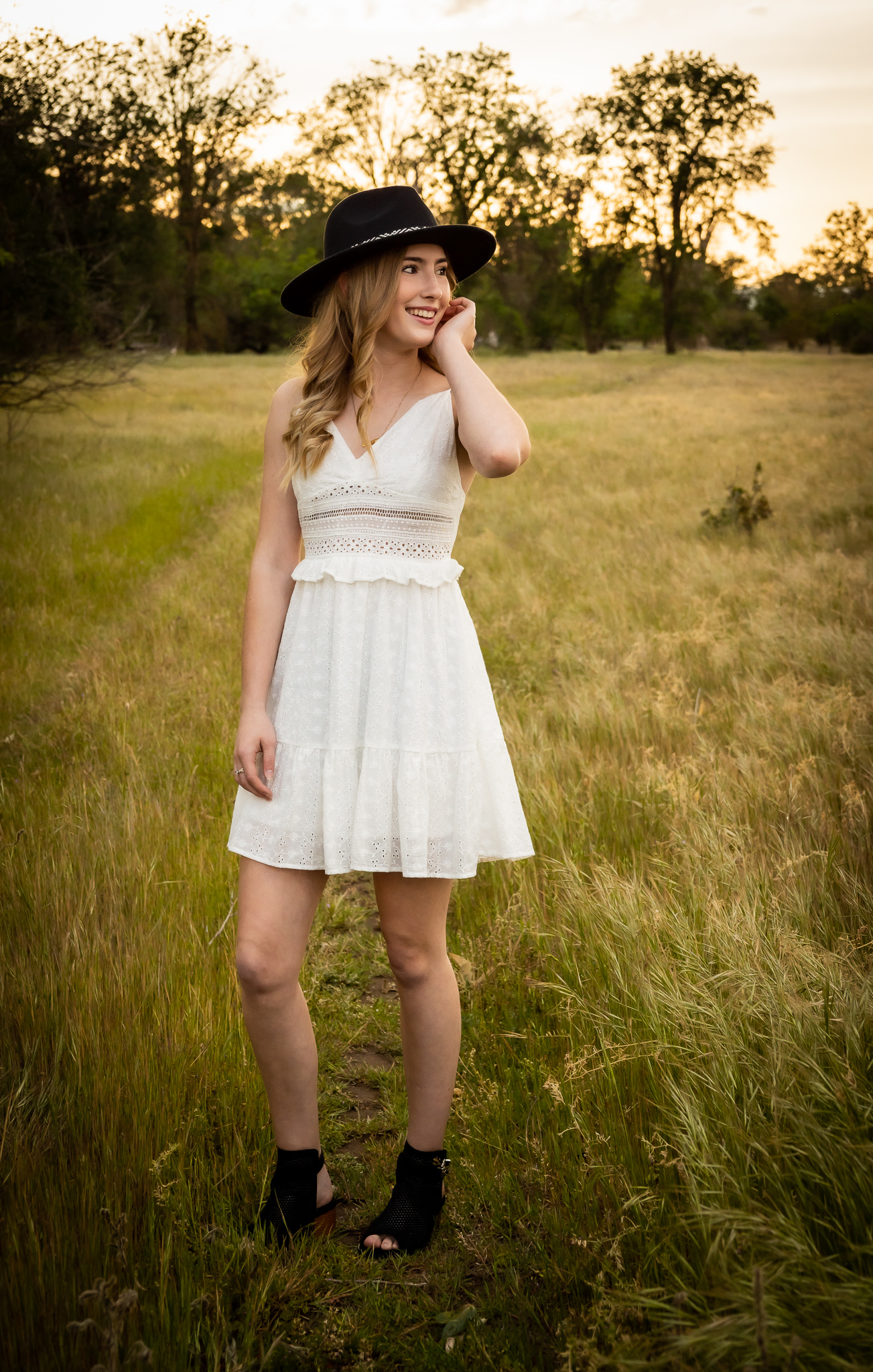 girl in white dress having senior pictures taken in red bluff ca