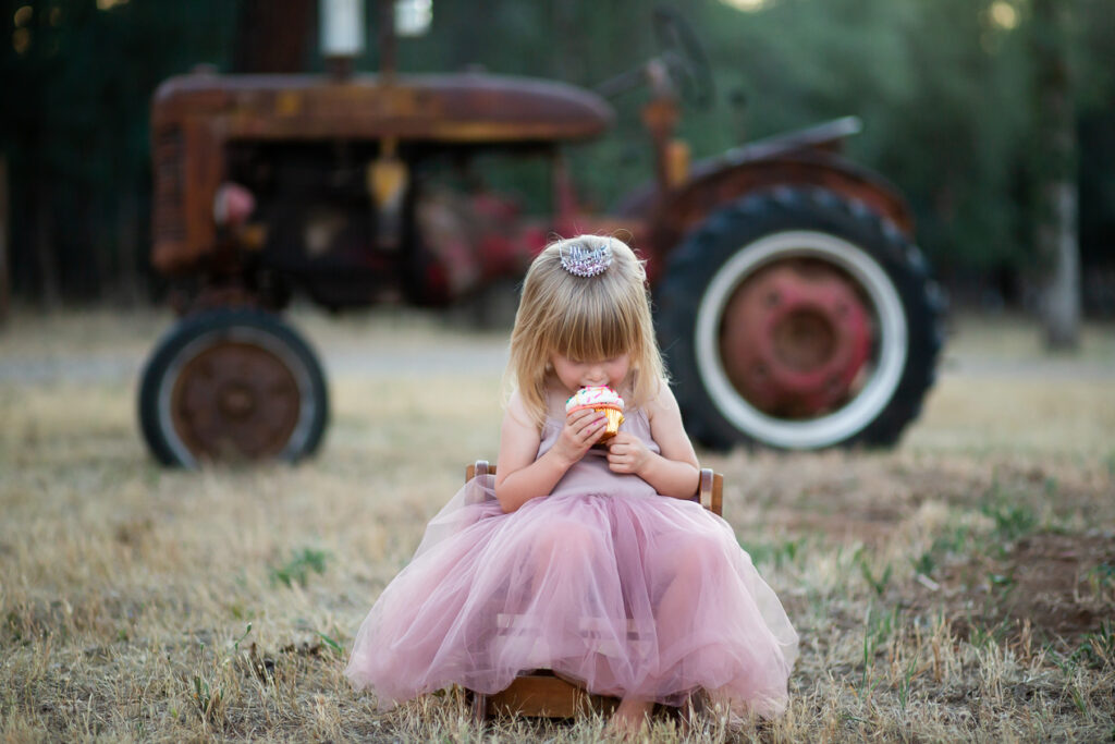 girl sitting by tractor during session in northern california 