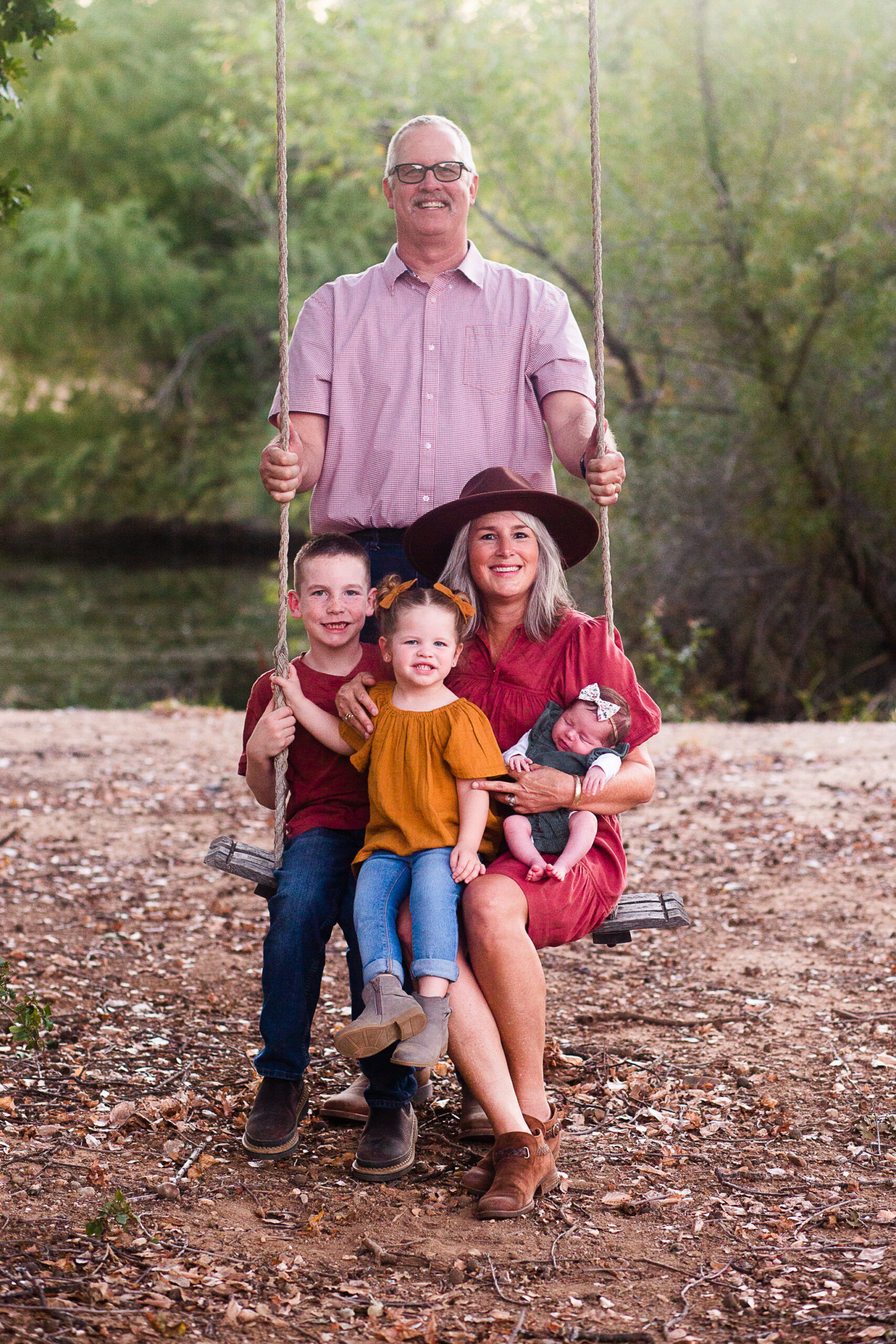 grandma swinging on swings with grandkids