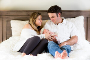 mom and dad holding baby