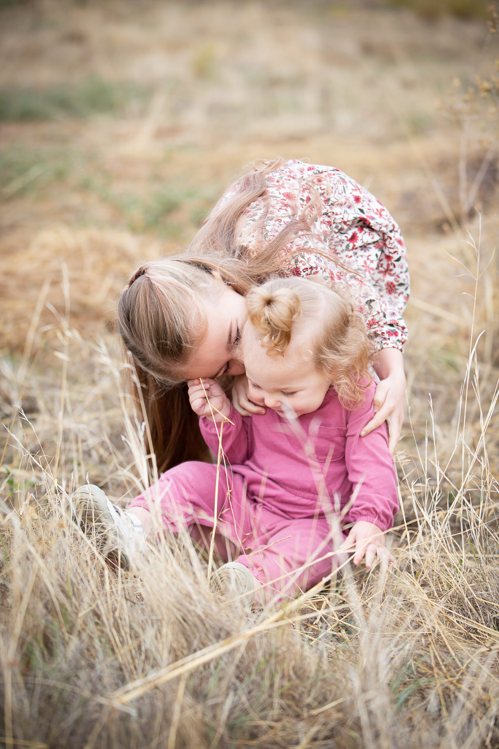 sisters playing in grass