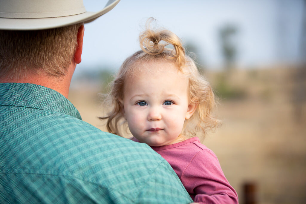 girl being held by dad