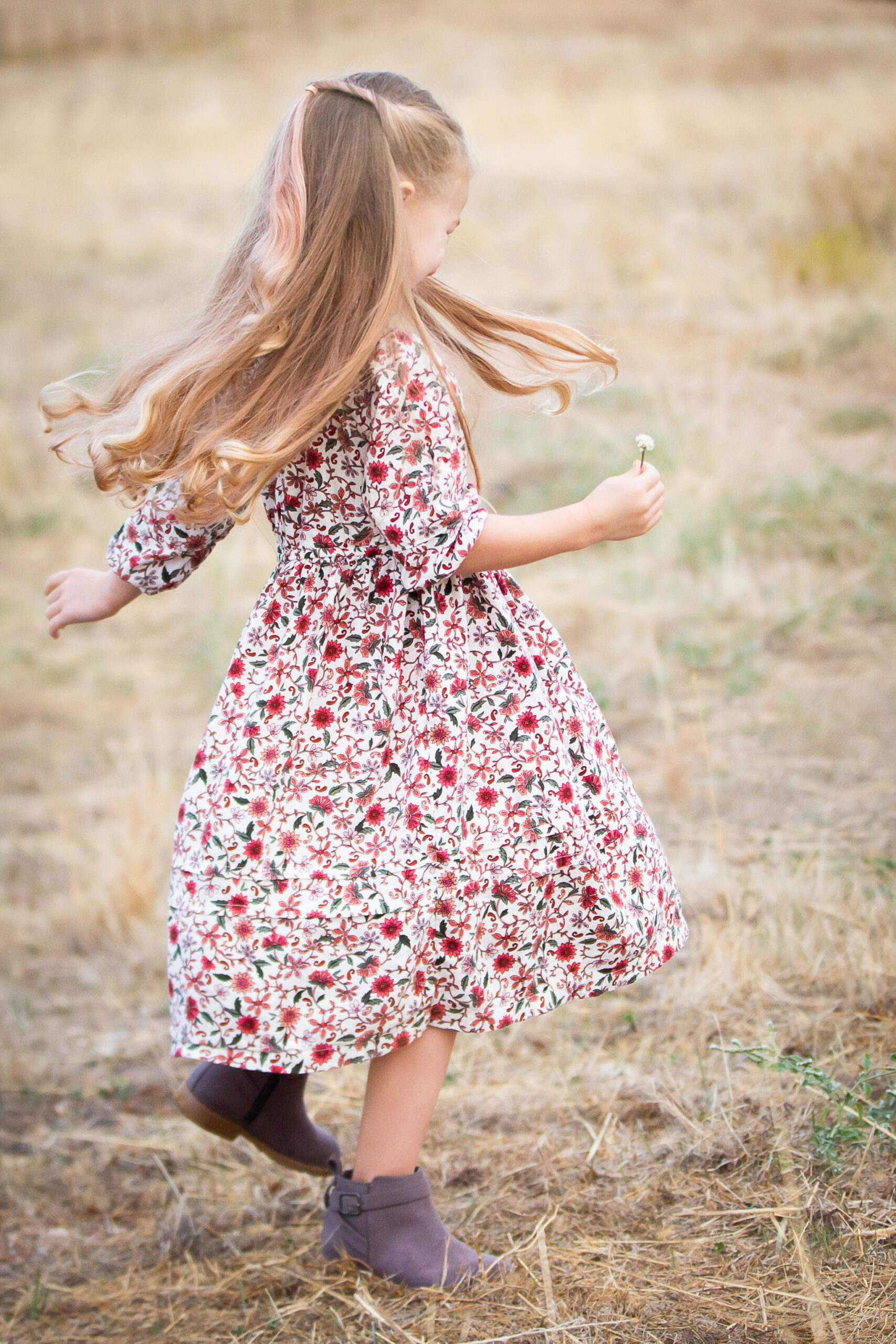 girl twirling in open field