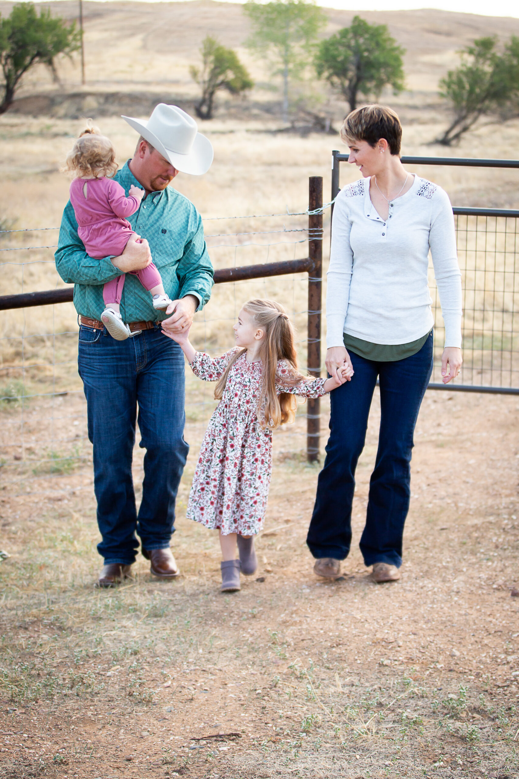 family walking in front of fence