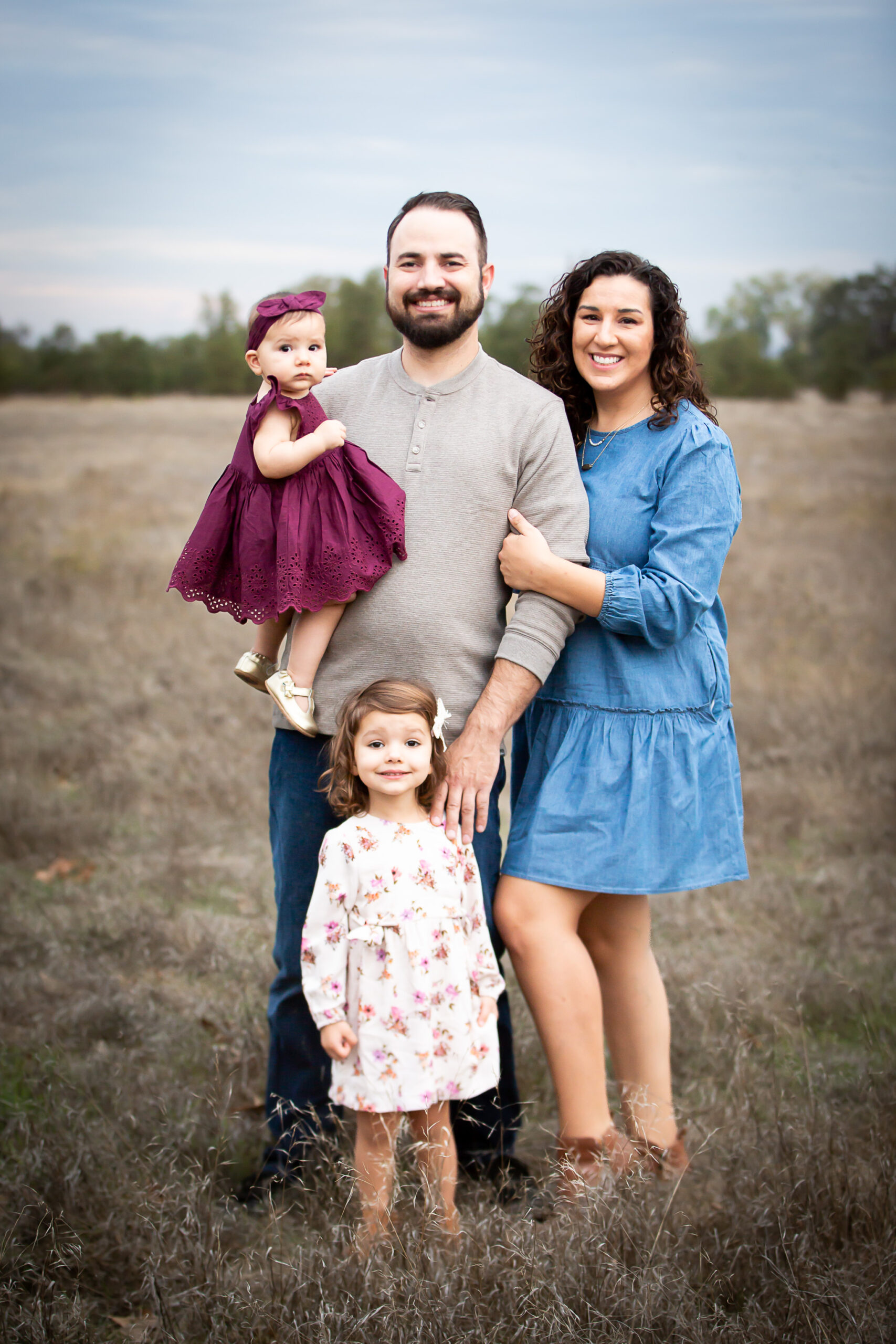 family standing in open field