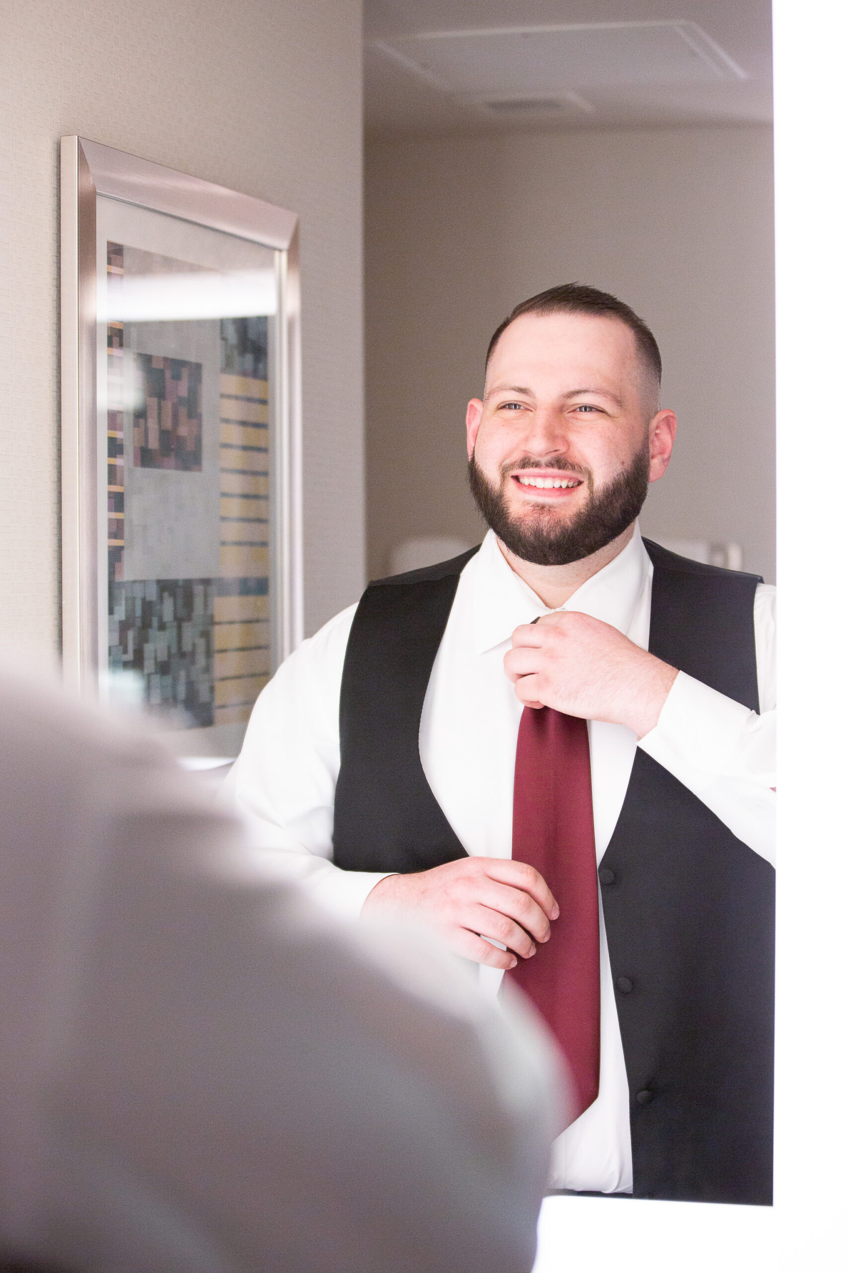 groom putting on tie