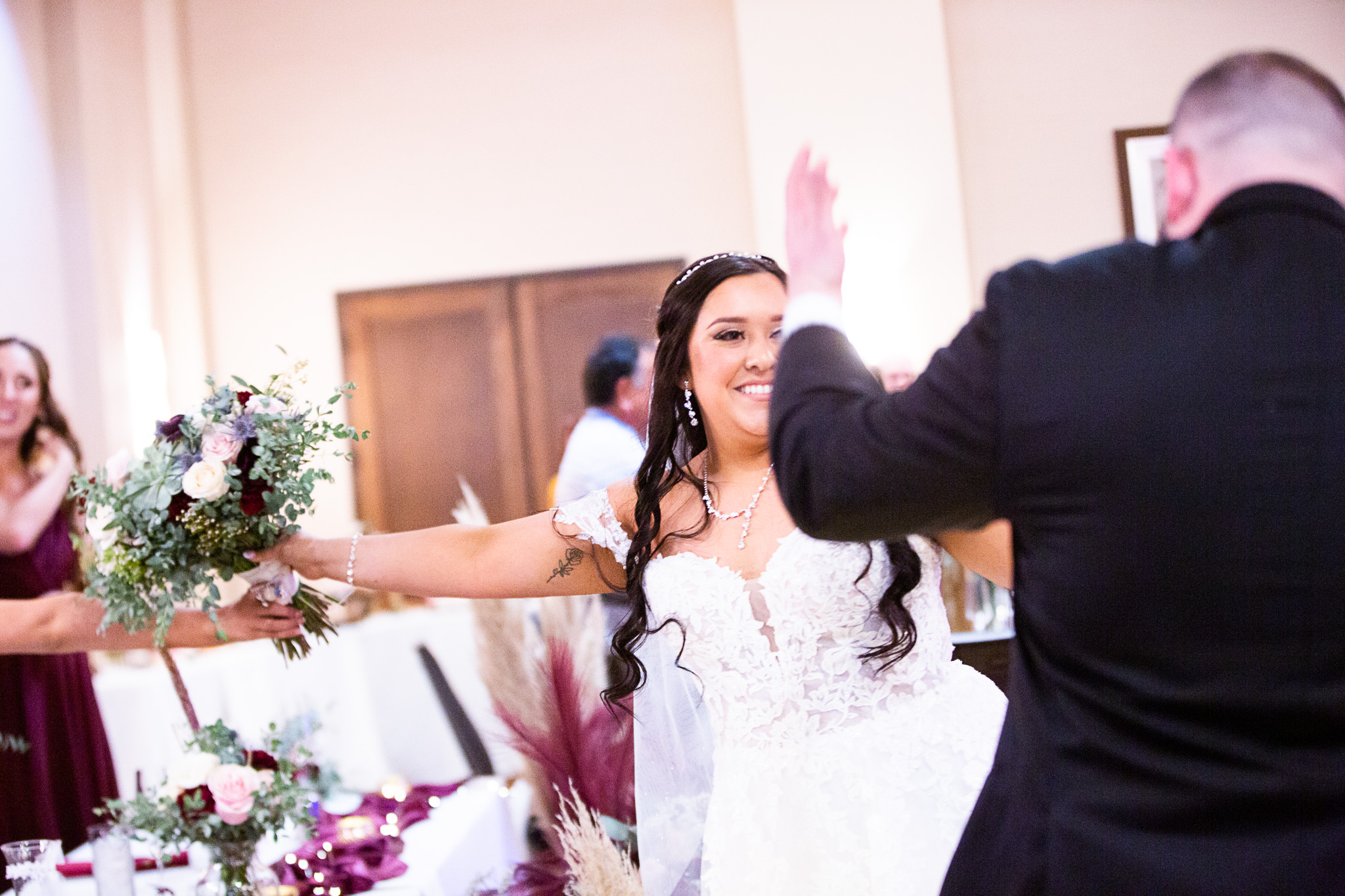 bride and groom walking into reception
