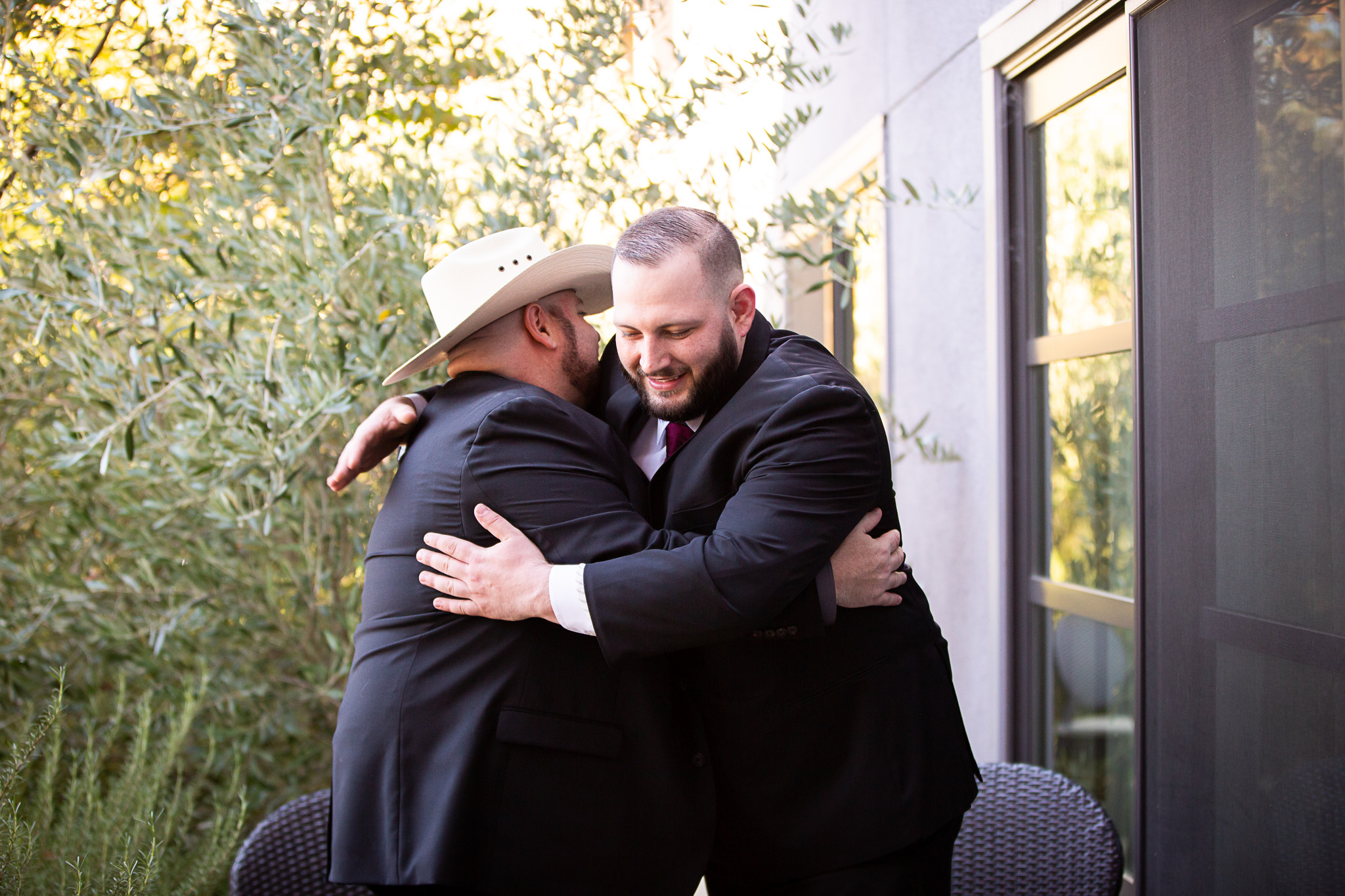 groom hugging dad on wedding day