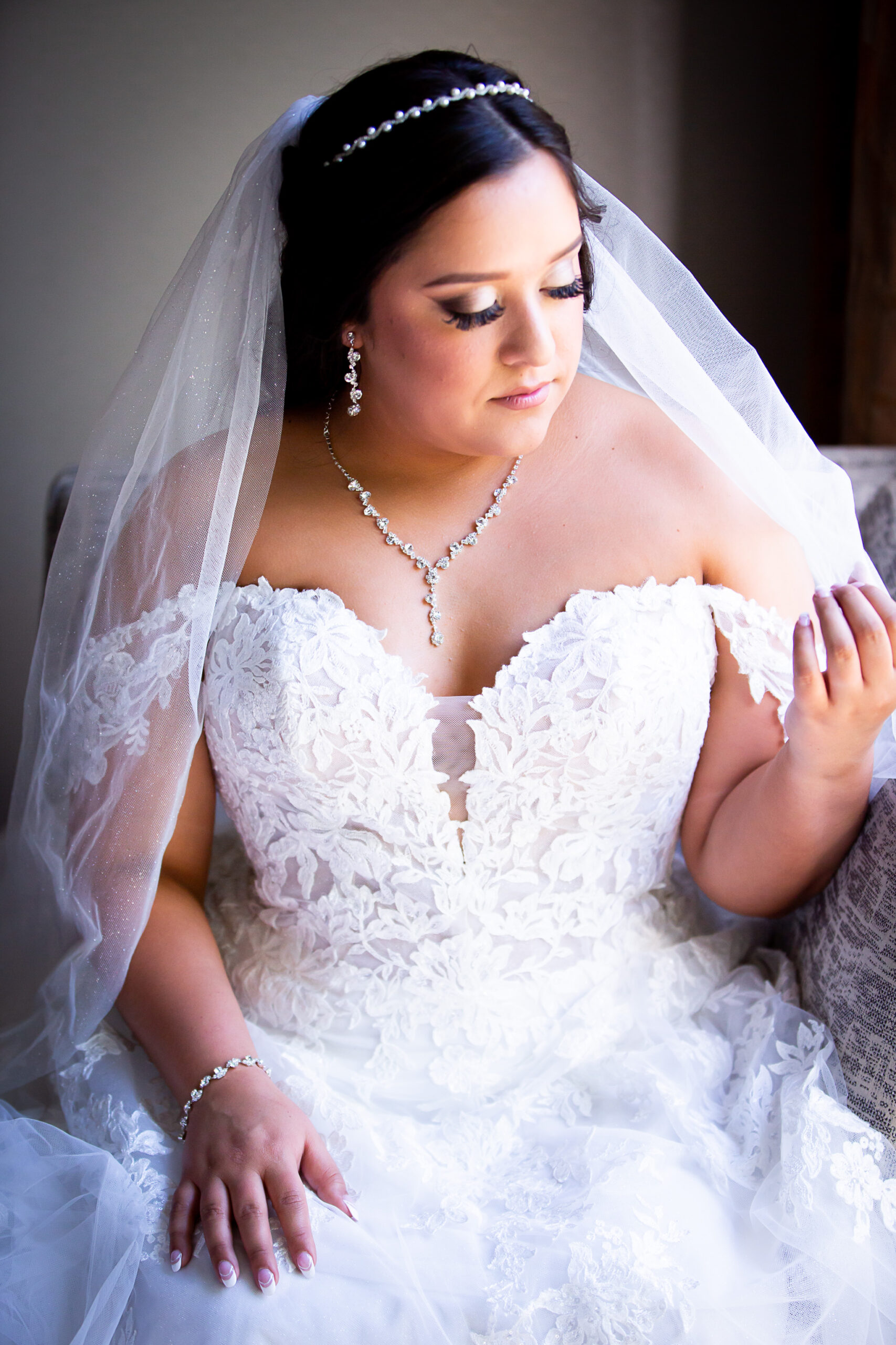 bride putting on veil