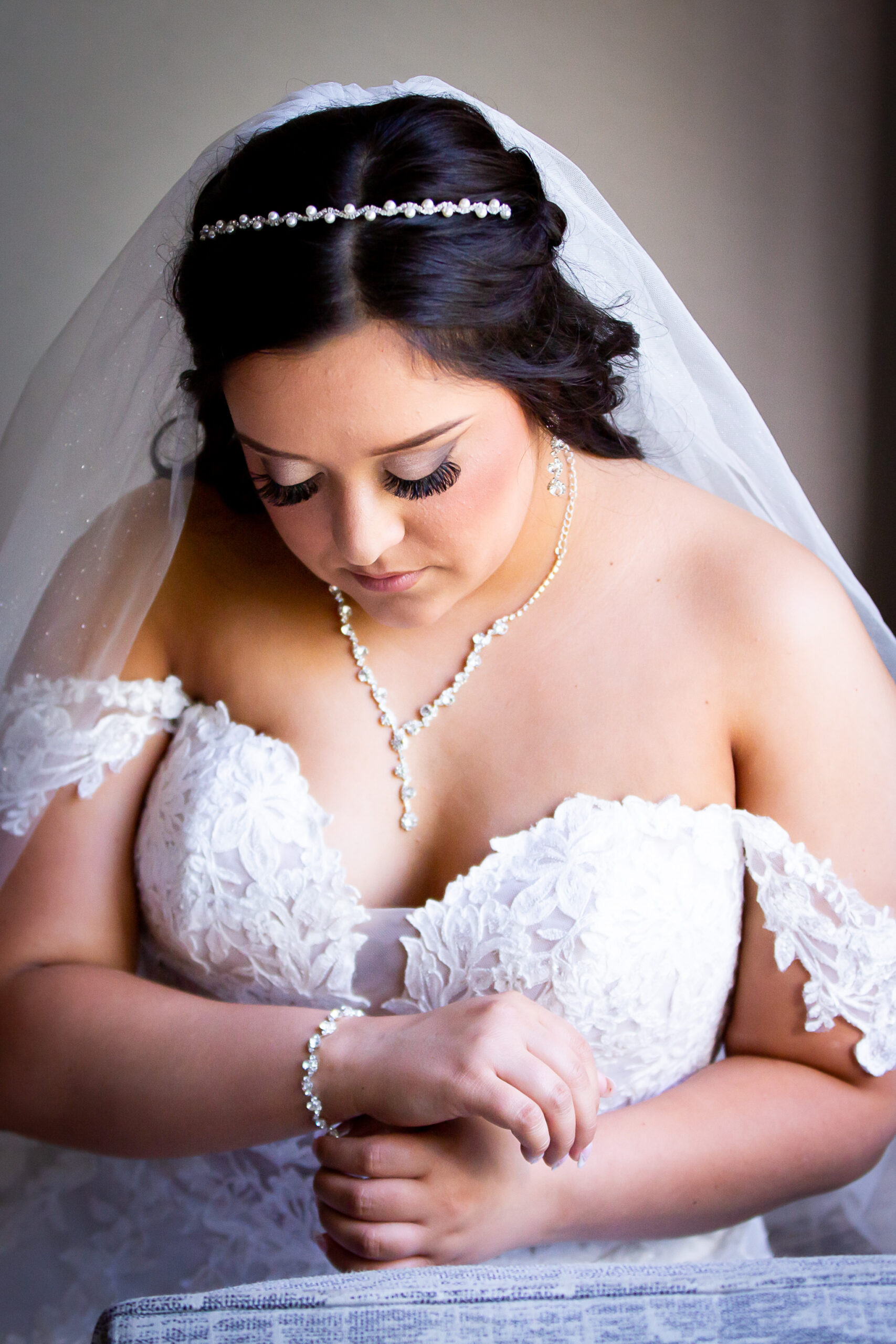 bride putting on bracelet
