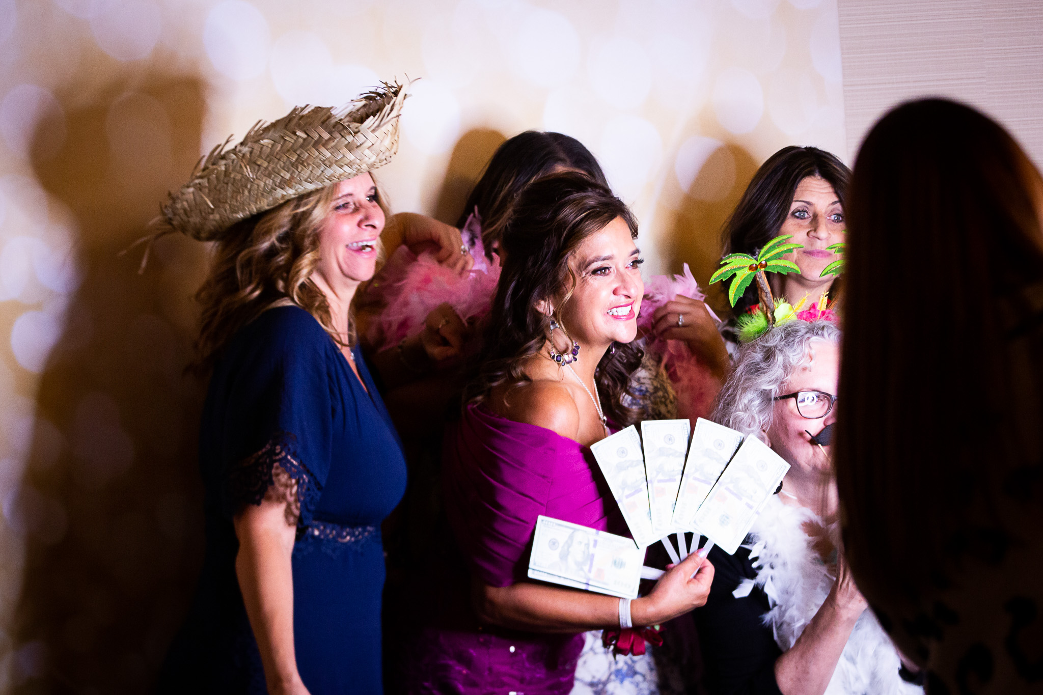 guests at wedding taking pictures at photo booth