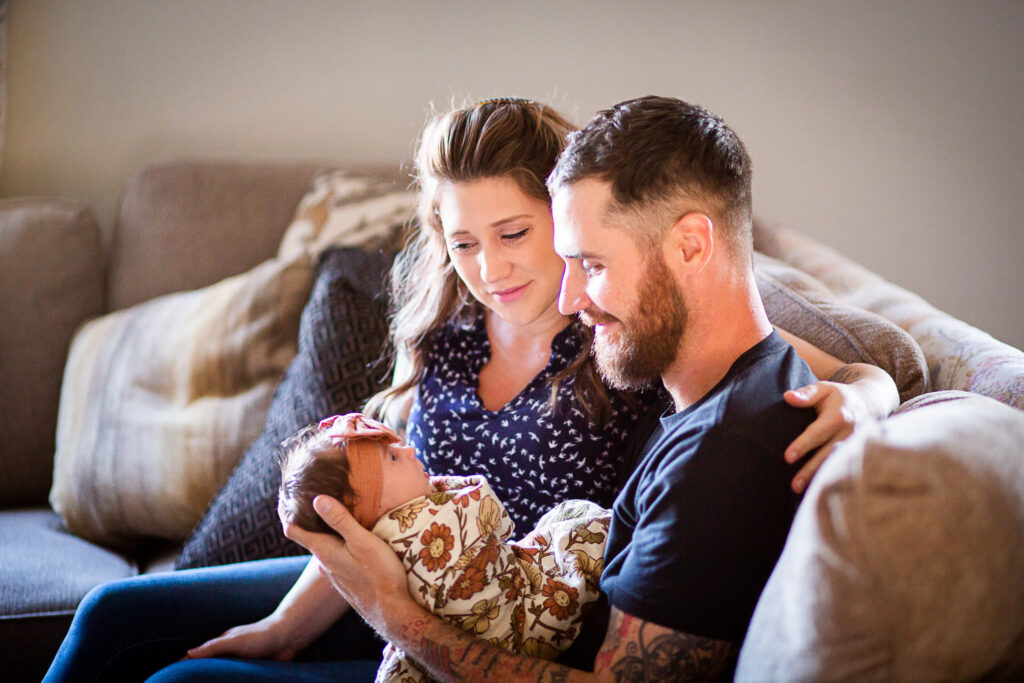 mom and dad looking at new baby red bluff lifestyle newborn session
