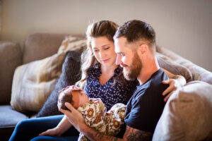 mom and dad looking at new baby
