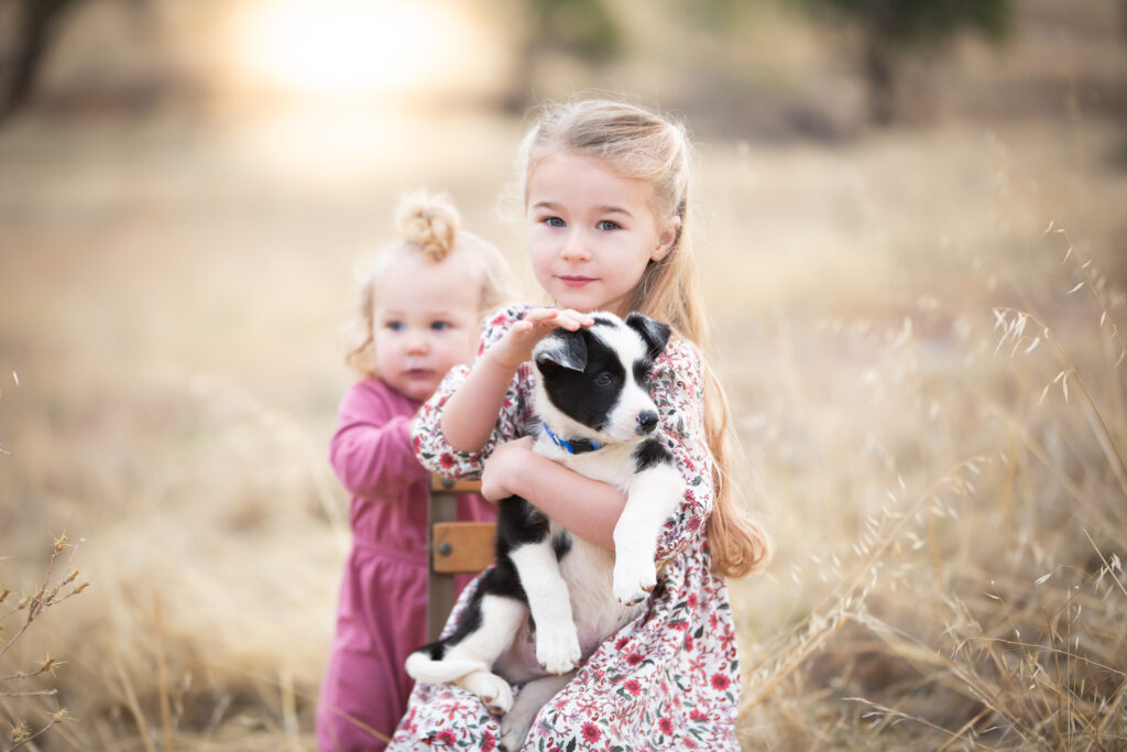 sisters playing with puppy