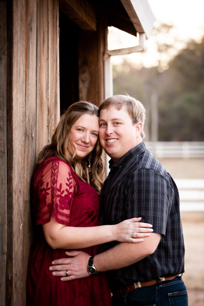 man and woman in front of barn