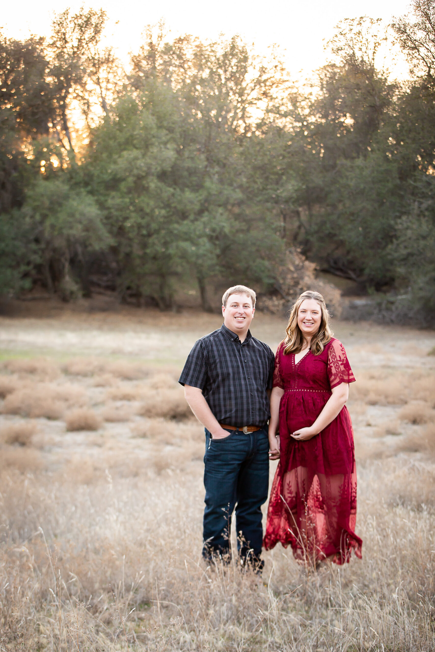 couple standing in field red bluff maternity photographer