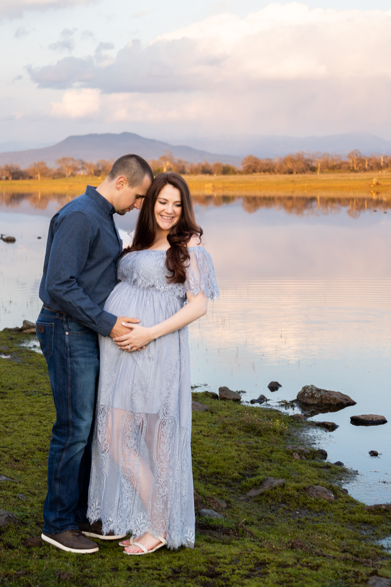couple standing next to hog lake 