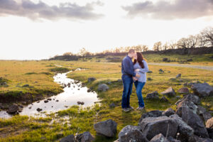 woman and man standing next to creek