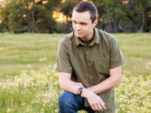 red bluff high school senior in field with flowers