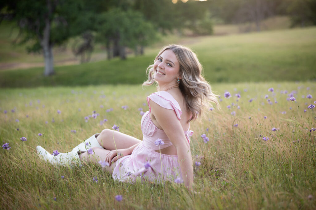 girl sitting in field wearing pink dress in red bluff ca
