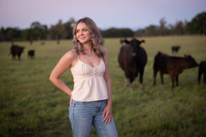 girl standing in field with Angus cattle in red bluff ca
