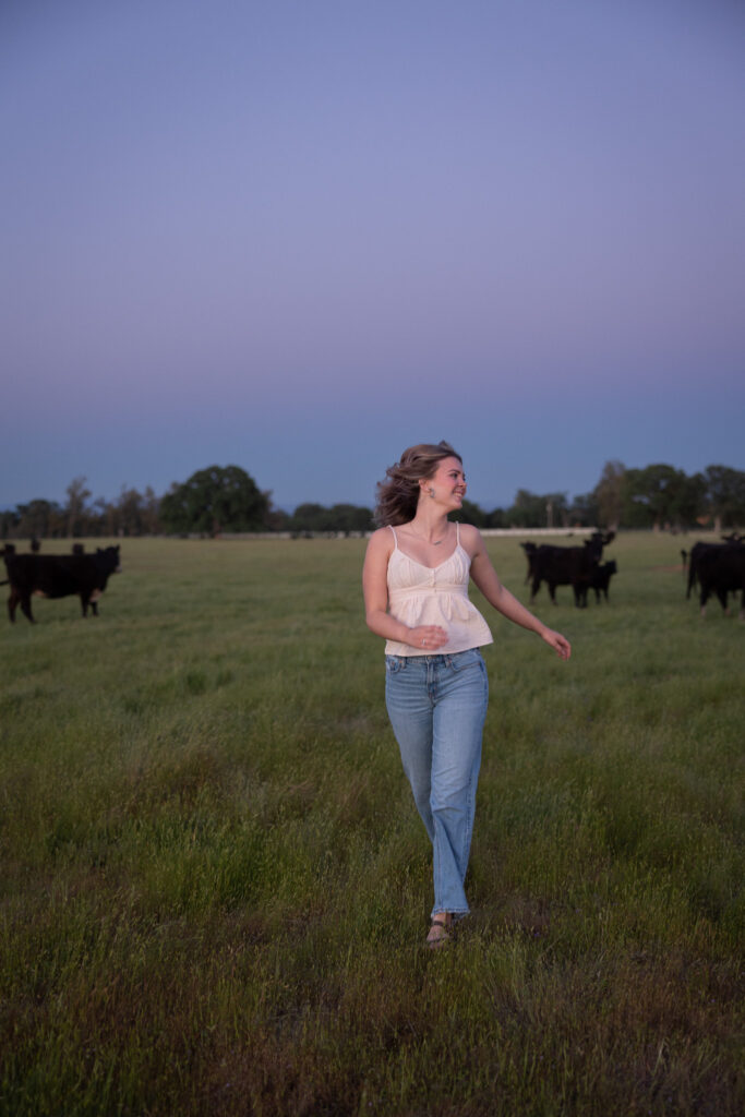 girl running through country field in red bluff ca